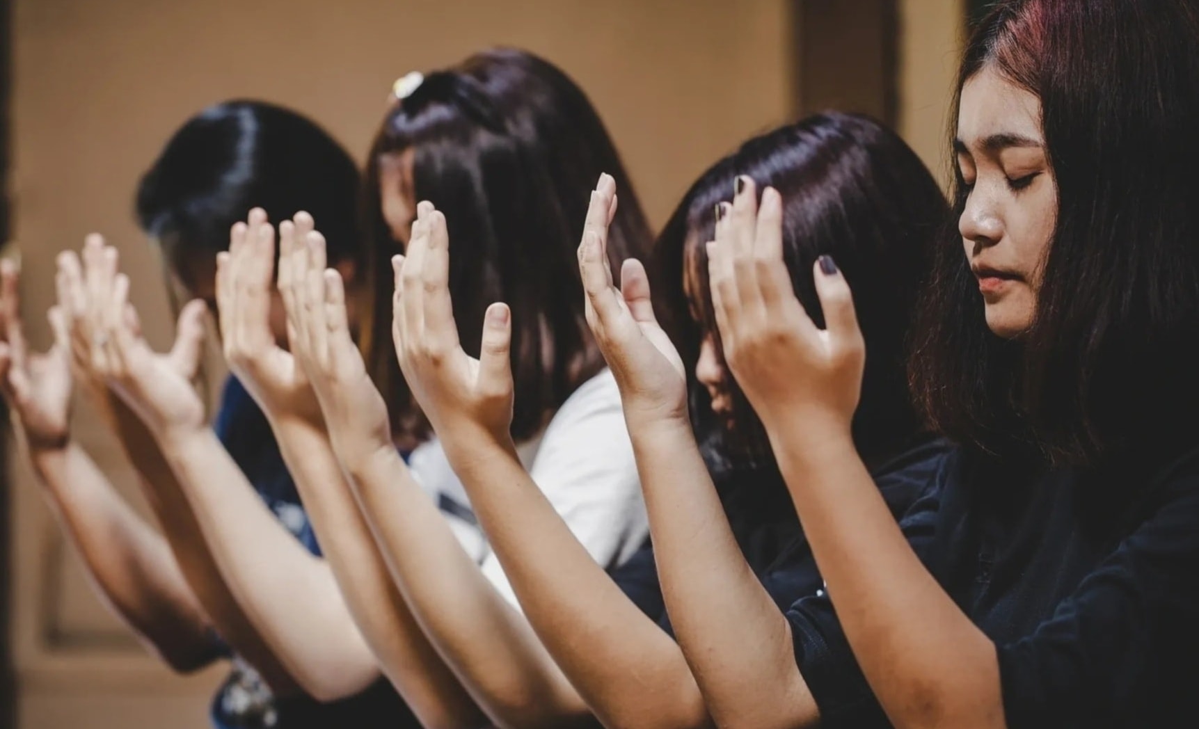 Women joining hands in faith, compassion, and community