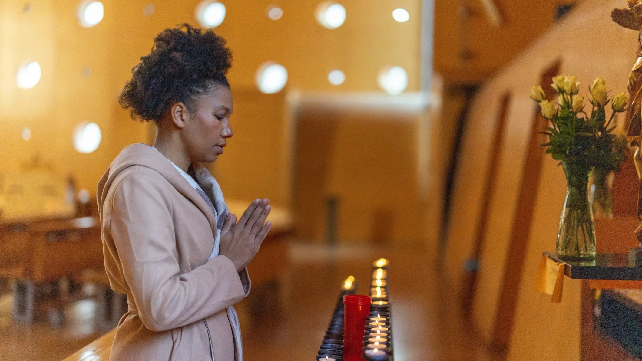Women kneeling together in worship and prayer